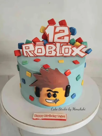 Another Roblox themed cake, this time for a 12th birthday. This one is bright and colorful, with the logo and character head surrounded by little blocks.