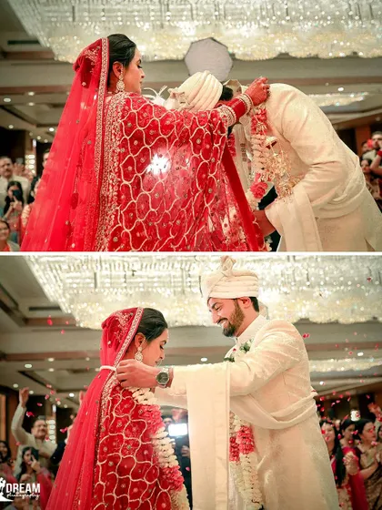 The 'varmala' or garland exchange ceremony, a key ritual in Indian weddings, captured beautifully.