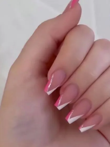 A modern twist on a classic, these square-shaped extensions feature a sharp, geometric V-shaped French tip design in both pink and white.