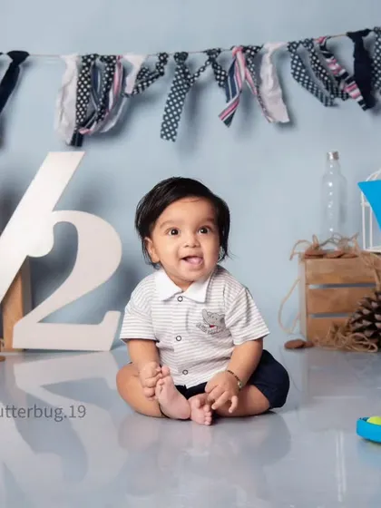 A happy six-month-old boy, Vayu, celebrating his half-birthday with a big smile in our simple and classic setup.
