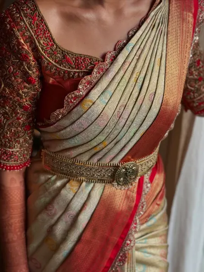 The final look of this traditional saree drape. The client looks elegant and regal, ready for her special day.