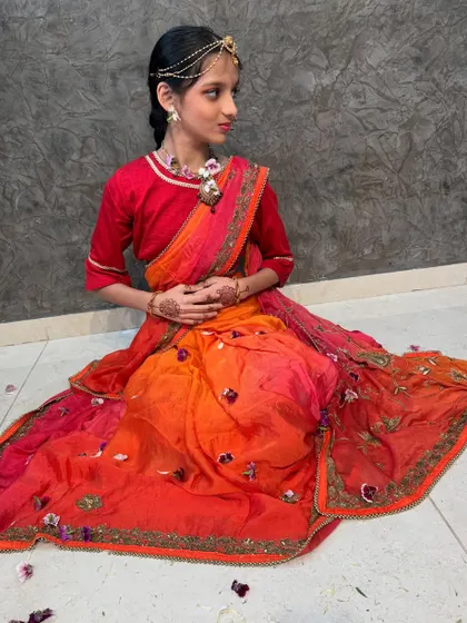 A side profile of the Radha look, showcasing the flow of the saree.