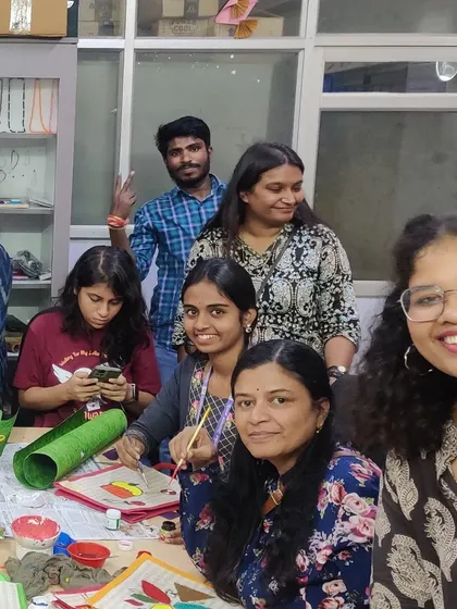 A happy group of volunteers and participants at a fabric painting session for a special school.
