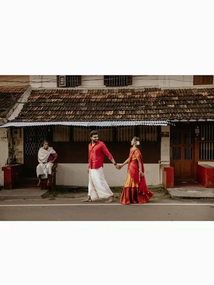 A cinematic shot of a couple walking down a village road, capturing a slice of life and love.