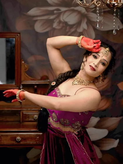 This full-length pose showcases the entire outfit and the graceful, dance-ready look. The makeup is designed to be long-lasting and picture-perfect.