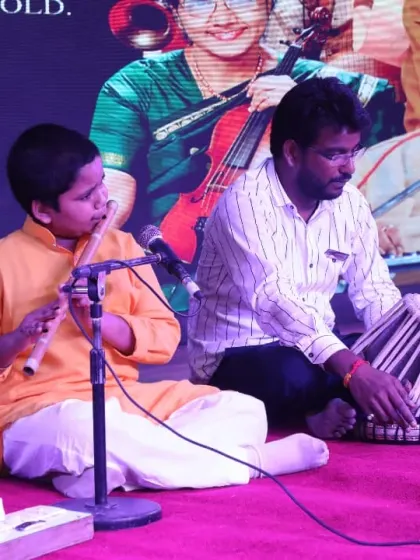 A student and teacher performing a flute and tabla duet on stage at our annual event. We encourage collaborative performances to teach students the art of listening and synchronizing with other musicians.