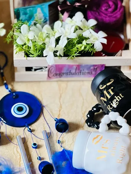 A detailed look at the items for a corporate wedding gift, including the "Mr & Mrs" mugs and an evil-eye dreamcatcher.