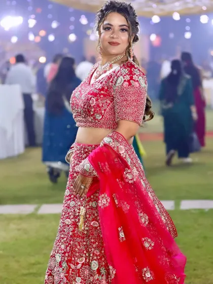 A full-length shot showing her beautiful red wedding lehenga, which she repurposed for the event.