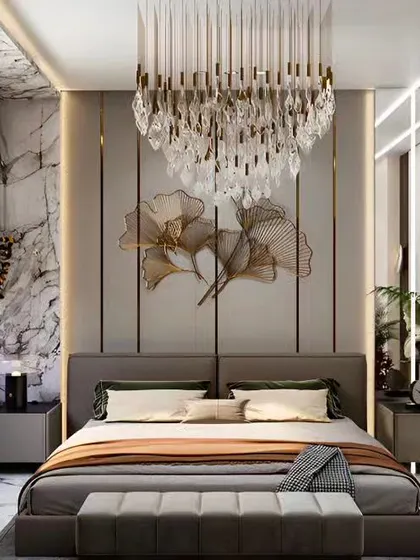 This opulent bedroom combines a stunning crystal chandelier with a marble-paneled accent wall. The gold accents and luxurious fabrics create a glamorous and sophisticated retreat fit for royalty.