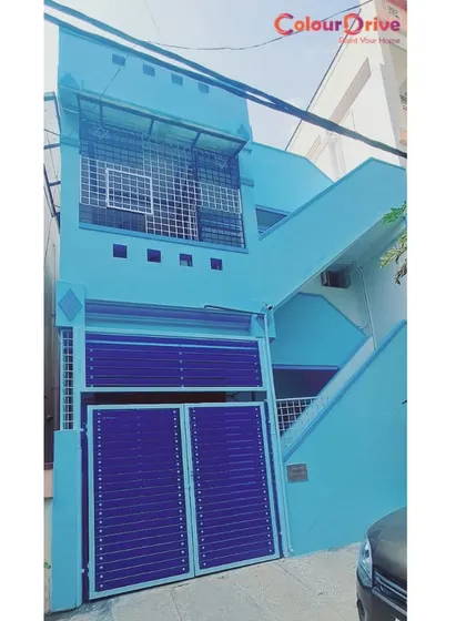 A bright and bold exterior color scheme using light blue for the walls and a deep royal blue for the gate. We help clients choose color combinations that enhance their home's curb appeal and stand out in the neighborhood.