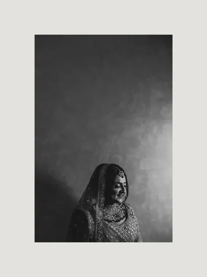 A moody and artistic black and white portrait of the bride, using shadow and light to create a sense of quiet elegance.