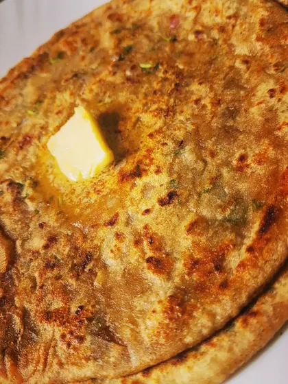 The perfect bite of Aloo Paratha, golden brown and filled with a delicious potato mixture.