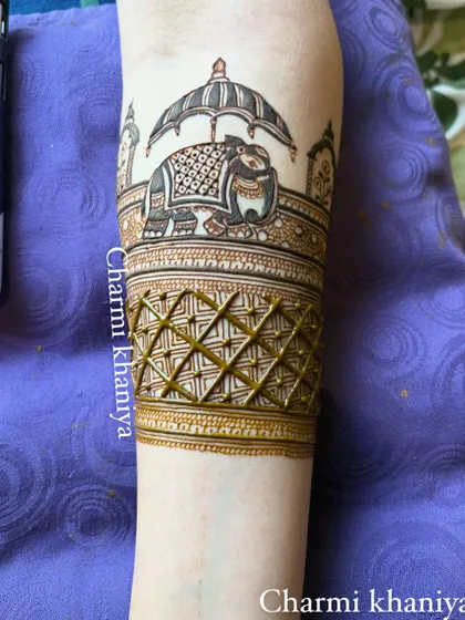 A simple yet regal bridal startup design for the arm. It features a majestic elephant under a royal umbrella, perfect for the beginning of a full bridal mehendi.