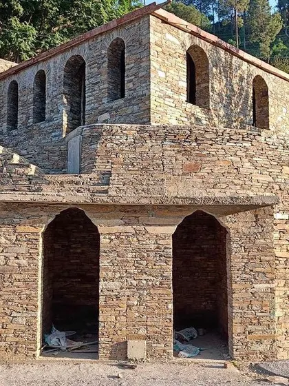 **Dharamshala Restoration, Uttarakhand:** The stone structure, built by Jasuli Devi, features beautiful arched openings. Our restoration work focuses on preserving these historical elements while making the building functional for modern use.