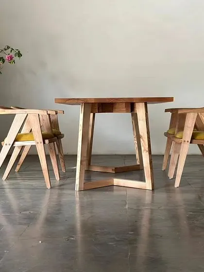 Our Straight Edge Dining Table in White Ash, shown with two matching accent chairs. The natural oil finish and modern concord legs create a piece that is perfect for stylish, contemporary gatherings.
