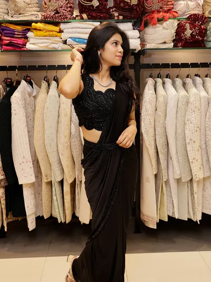 A full view of the black pre-draped saree, highlighting its flattering silhouette.