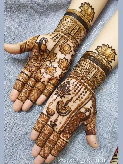A perfect design for Diwali, this mehndi features hanging diyas, peacocks, and lotus flowers. The combination of these auspicious symbols creates a wonderfully festive feel.