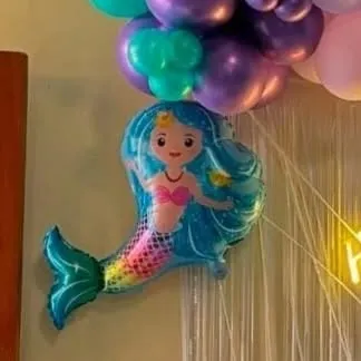 A close-up of a mermaid foil balloon, one of the many themed elements we use to bring a character party to life.