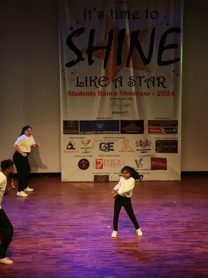 One of our talented young dancers takes center stage during a group performance, showcasing her skills and confidence.