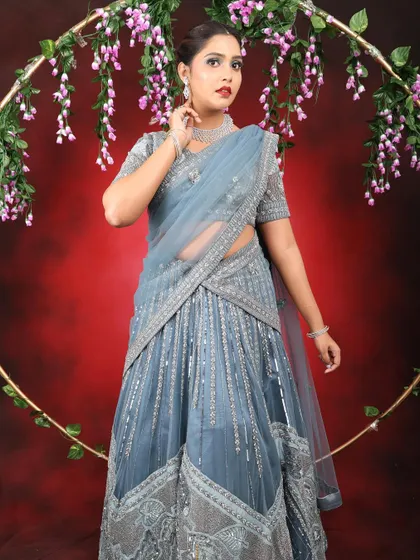 Behind every picture is the effort of a full team. This look features a cool-toned silver and blue smokey eye with a bold red lip, perfect for a reception or cocktail event.
