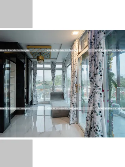 This interior shot shows the walk-in closet area with floor-to-ceiling glass windows. The design maximizes natural light and provides stunning views, making even a functional space feel open and luxurious.