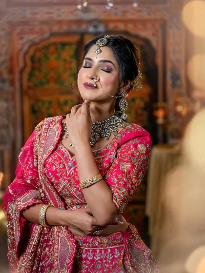 A serene shot of the bride with her eyes closed, showcasing the beautiful blend of eyeshadows and the perfect bridal glow on her skin.