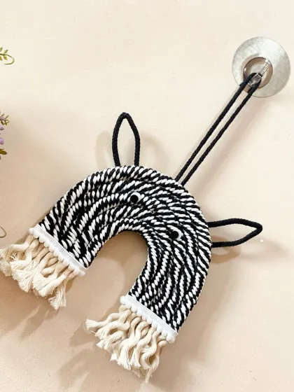 A fun and graphic zebra wall hanging. The black and white striped pattern makes this a modern and playful addition to a monochrome-themed room.