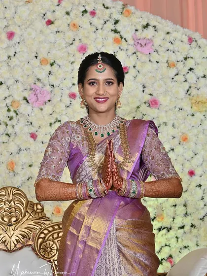 A beautiful portrait of Jagruthi at her Varpooje, with a stunning floral backdrop.