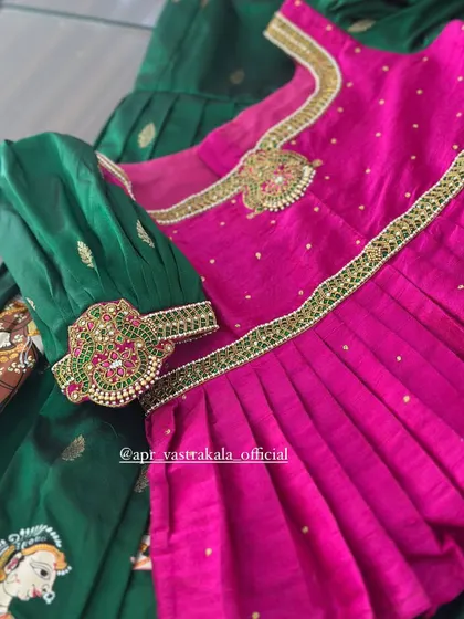The intricate handwork on the sleeve cuff of the kids' blouse, featuring kemp stones and beadwork that matches the richness of the hand-painted skirt.