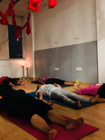 The final, most important part of any class is deep relaxation. Here, my students are in Savasana, or corpse pose, integrating the benefits of their practice and finding complete rest in a restorative yoga session.