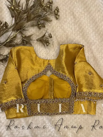 The full view of the mustard yellow blouse, showing the beautiful balance between the heavy embroidery and the simple elegance of the fabric.