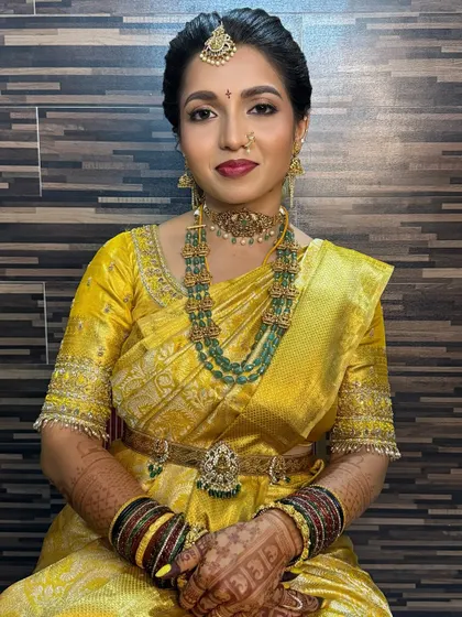 My beautiful bride Diksha on her muhurtham day. This look features a subtle, glowy finish with a bold lip and golden shimmery eyes, perfect for her yellow Kanchipuram silk saree.