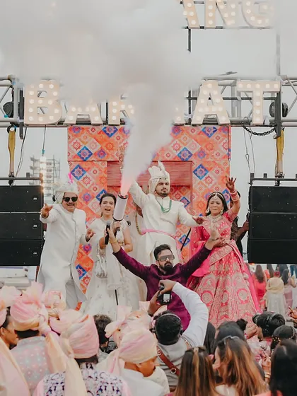 An epic shot with the entire wedding party on the baraat truck, surrounded by smoke and cheers. I am right there in the middle, fueling the excitement.