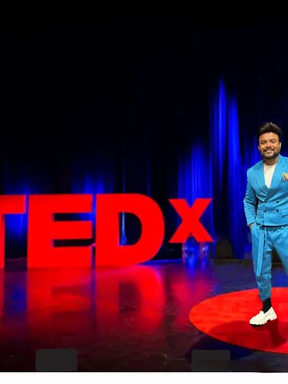 A wide shot of me on the iconic red circle of the TEDx stage.