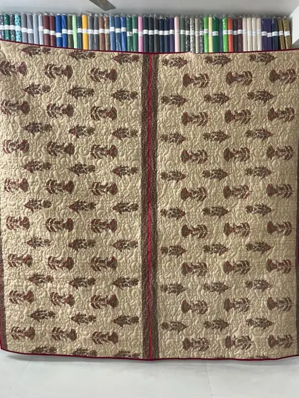 A collection of reversible memory quilts crafted from the sarees of a client's mother. Each side tells a different story, preserving the fabric's patterns and colors in a new, functional form.