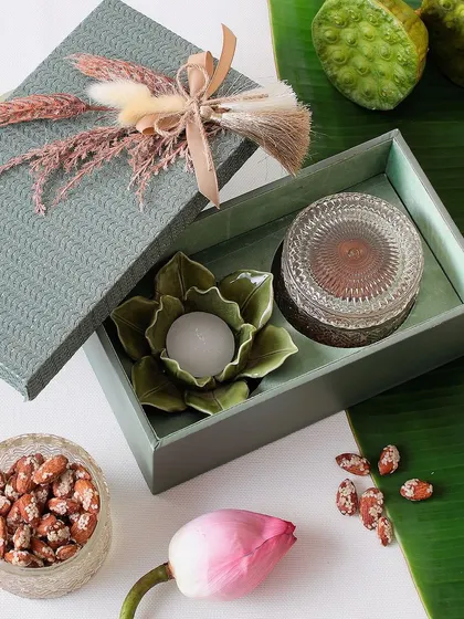This simple and elegant Diwali hamper includes a beautiful flower candle and a jar of our crunchy sesame almonds.