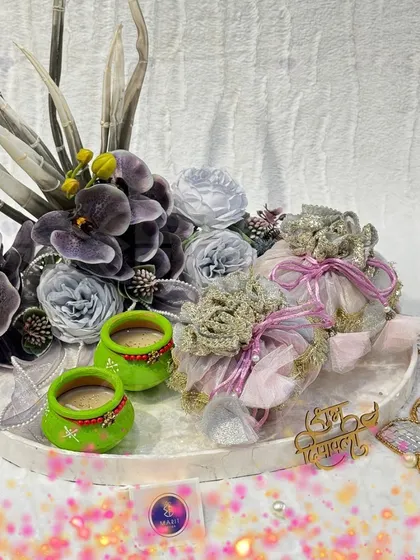 My Diwali Edit is live! This hamper, in shades of purple and green, features hand-painted 'diyas', elegant dry fruit 'potlis', and floral-themed 't-light' holders.