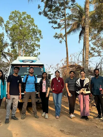 A team ready to start their Uttari Betta trek, standing by the transport vehicle. We ensure a smooth logistical experience from start to finish.