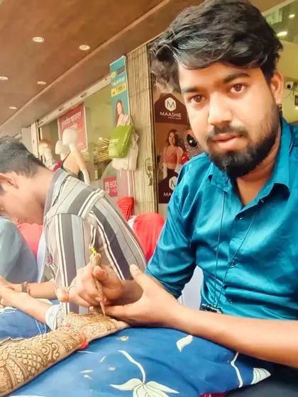This is me, Bunty, completely focused on my craft. I bring this level of dedication to every client, ensuring your mehandi is nothing short of perfect.