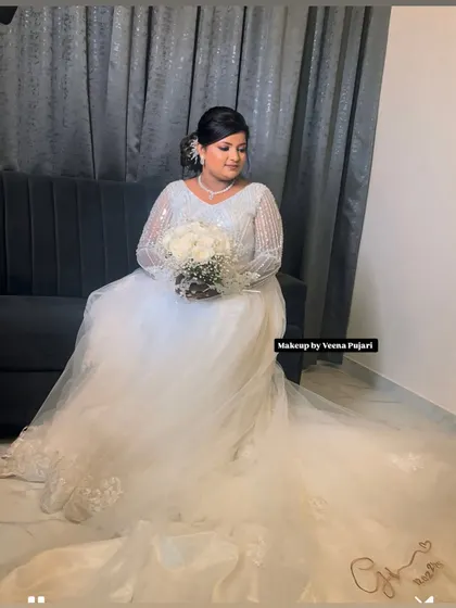 A full-length view of this gorgeous bride in her wedding gown. The makeup is designed to look timeless and elegant, ensuring she looks perfect in all her wedding photos.