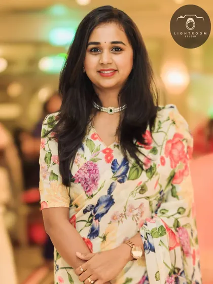 A professional photo of the client in her floral saree, looking absolutely radiant.