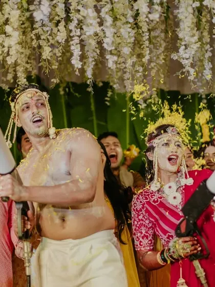 The couple takes charge of the smoke cannons, adding to the fun of their own Haldi party.