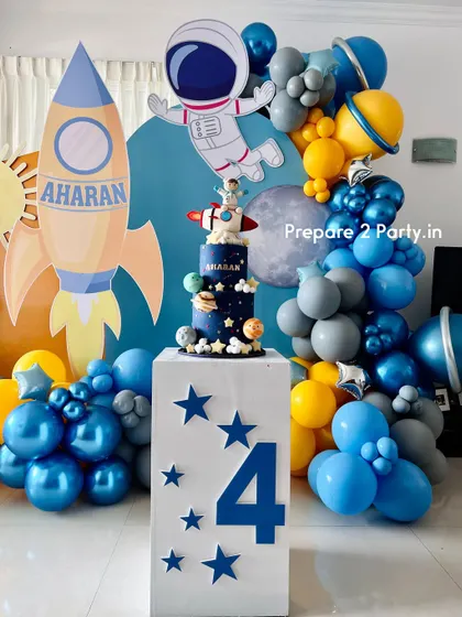 Blast off with my space-themed party decorations. These setups feature custom backdrops of the moon and sun, balloon garlands with chrome and planet balloons, and themed cake displays.