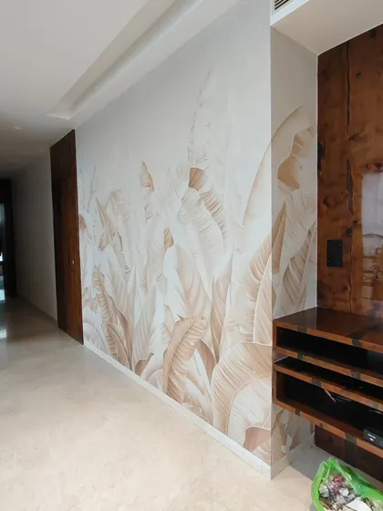 A full view of a subtle, beige-toned banana leaf mural I installed in a Goregaon home. The design complements the wooden furniture and adds a soft, natural texture to the living space.