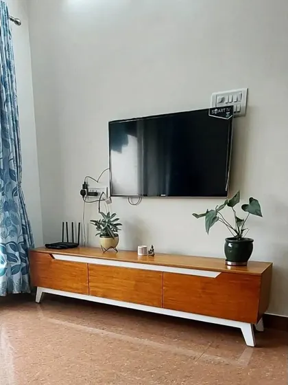 A slightly different perspective of the TV console from image 288, highlighting its clean design and practical use in a real home setting.