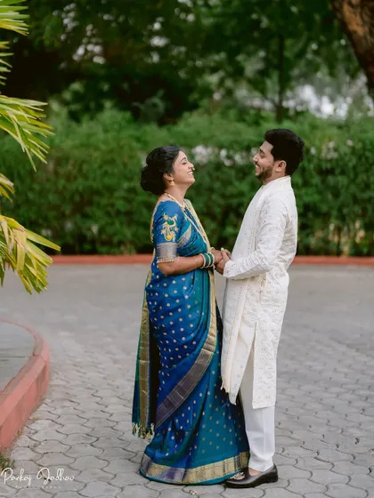 A happy, natural interaction between Tanuja and Abhishek, framed by lush greenery.
