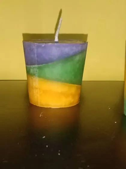 A set of three handmade candles with different colored layers. These show the variety of color combinations I can create for a vibrant, multi-color decoration theme.