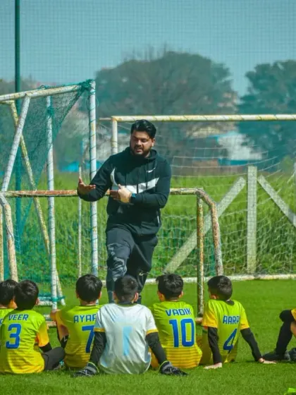 A coach gives a halftime talk to his young team, providing guidance and motivation for the second half.