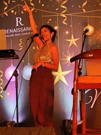 A duplicate of a happy moment on stage, pointing to the crowd during a festive gig. My goal is always to create a shared experience and get everyone involved.