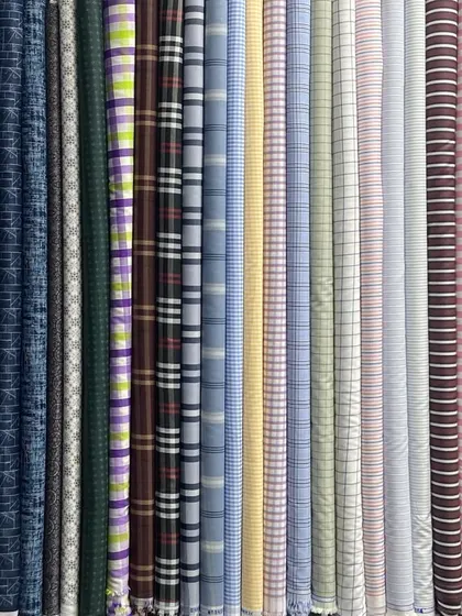 It all starts with the fabric. Here is a small part of my extensive collection of pure cotton shirt materials, featuring a variety of checks, stripes, and prints for you to choose from.